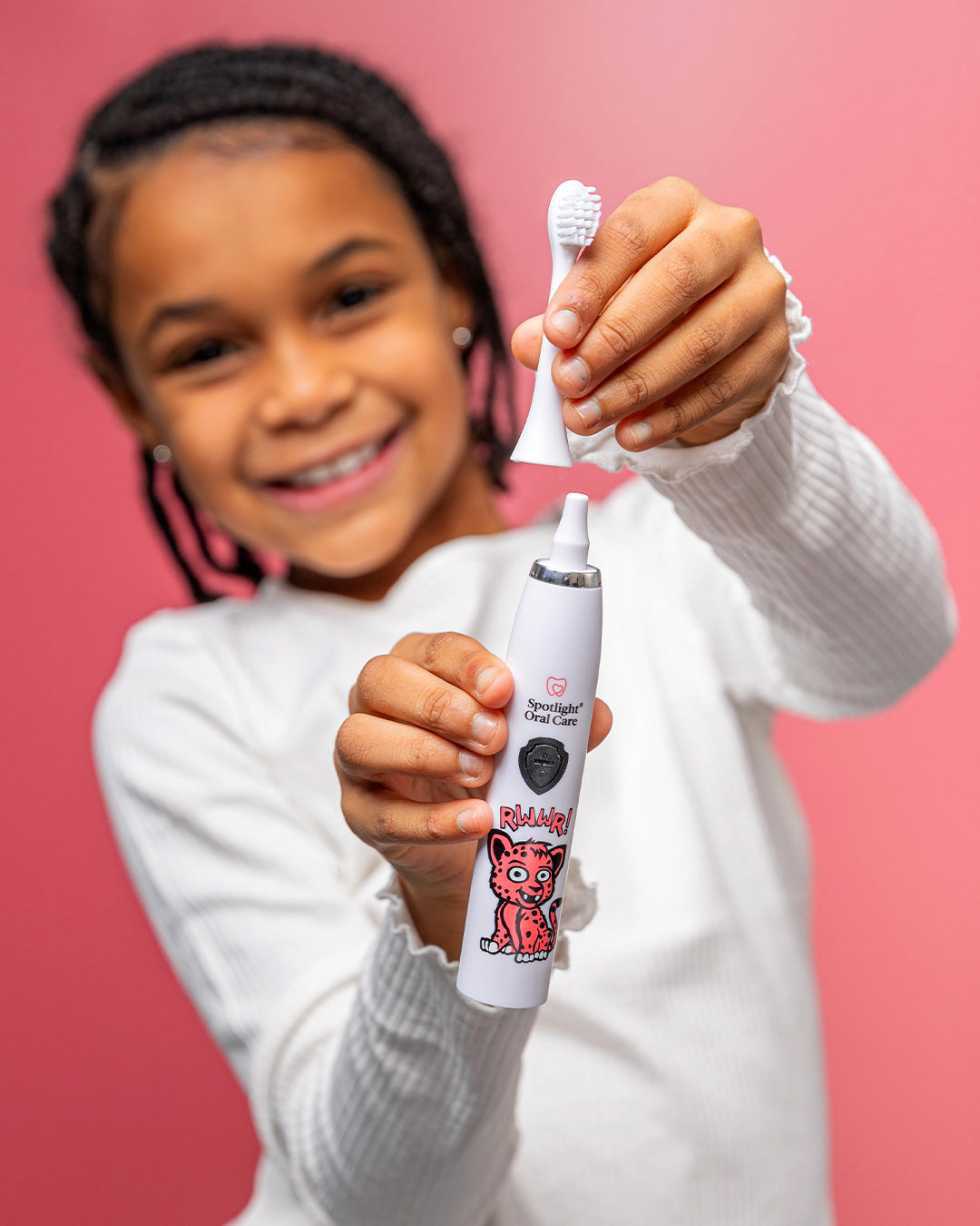 Dentist-developed kids' toothbrush with a textured grip handle, promoting independence and effective plaque removal​