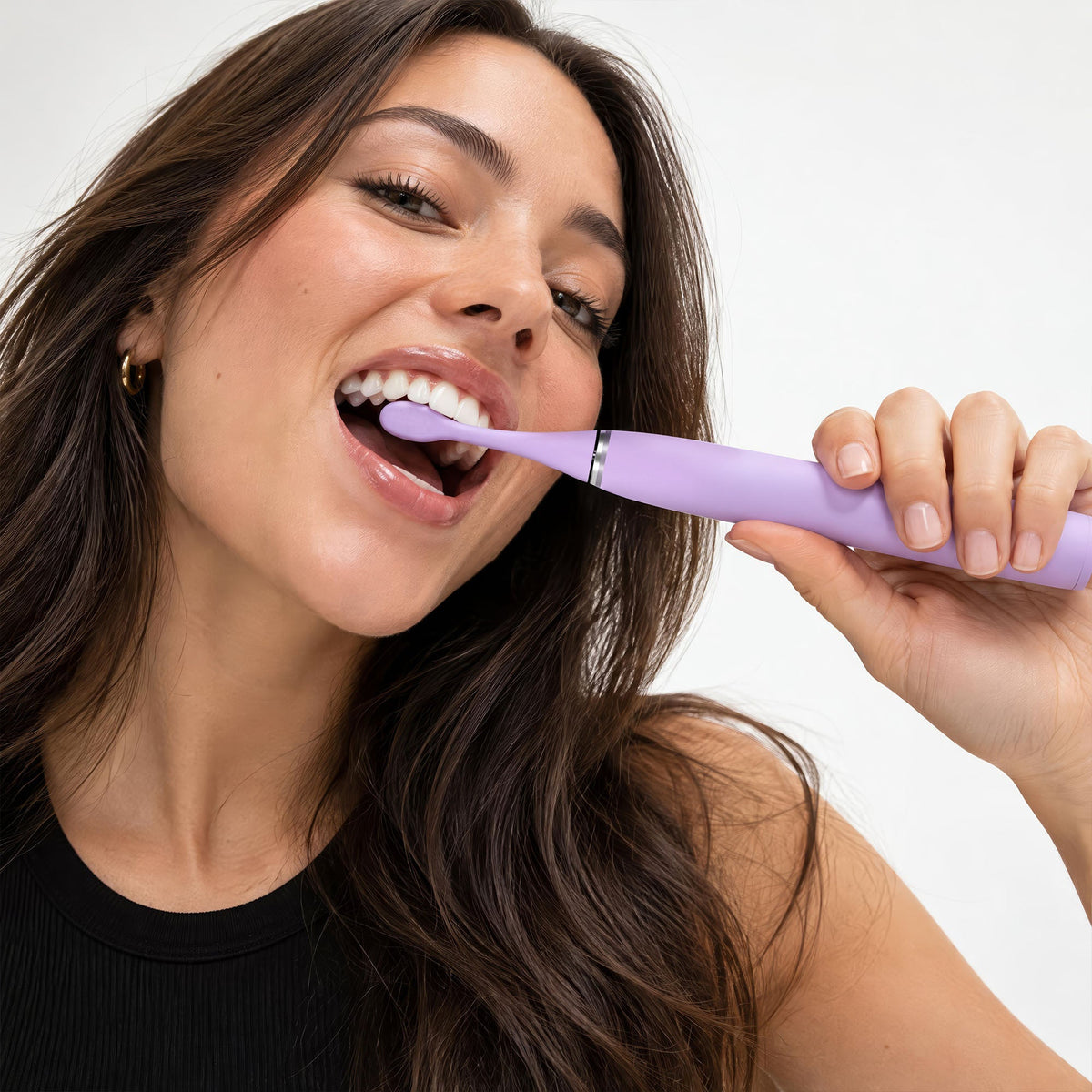Woman brushing with the limited edition Wisteria Purple Sonic Pro