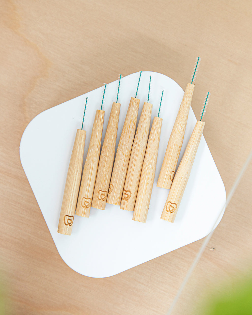 Set of 8 bamboo interdental brushes available in sizes 0.4mm to 0.7mm, ergonomically designed to suit various tooth sizes and shapes​