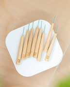 Set of 8 bamboo interdental brushes available in sizes 0.4mm to 0.7mm, ergonomically designed to suit various tooth sizes and shapes​